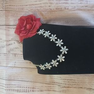 silvertone necklace with crystal style flowers. really shines in the sun.